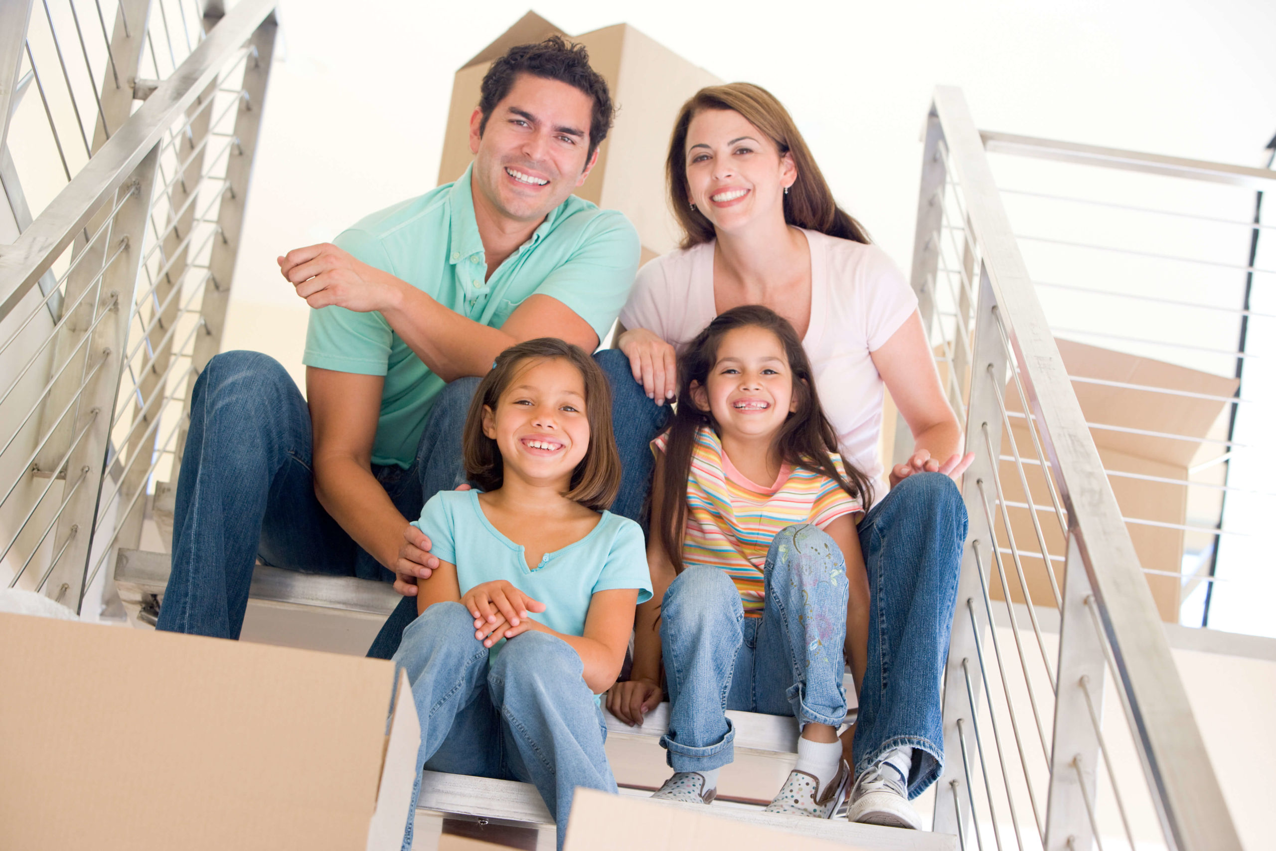 Happy Family with two daughter seating on the stairs